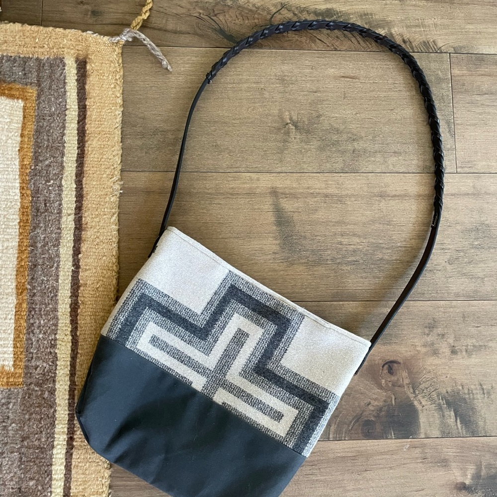 Pendleton fabric crossbody purse w/ wax cloth bottom. Interior pocket.